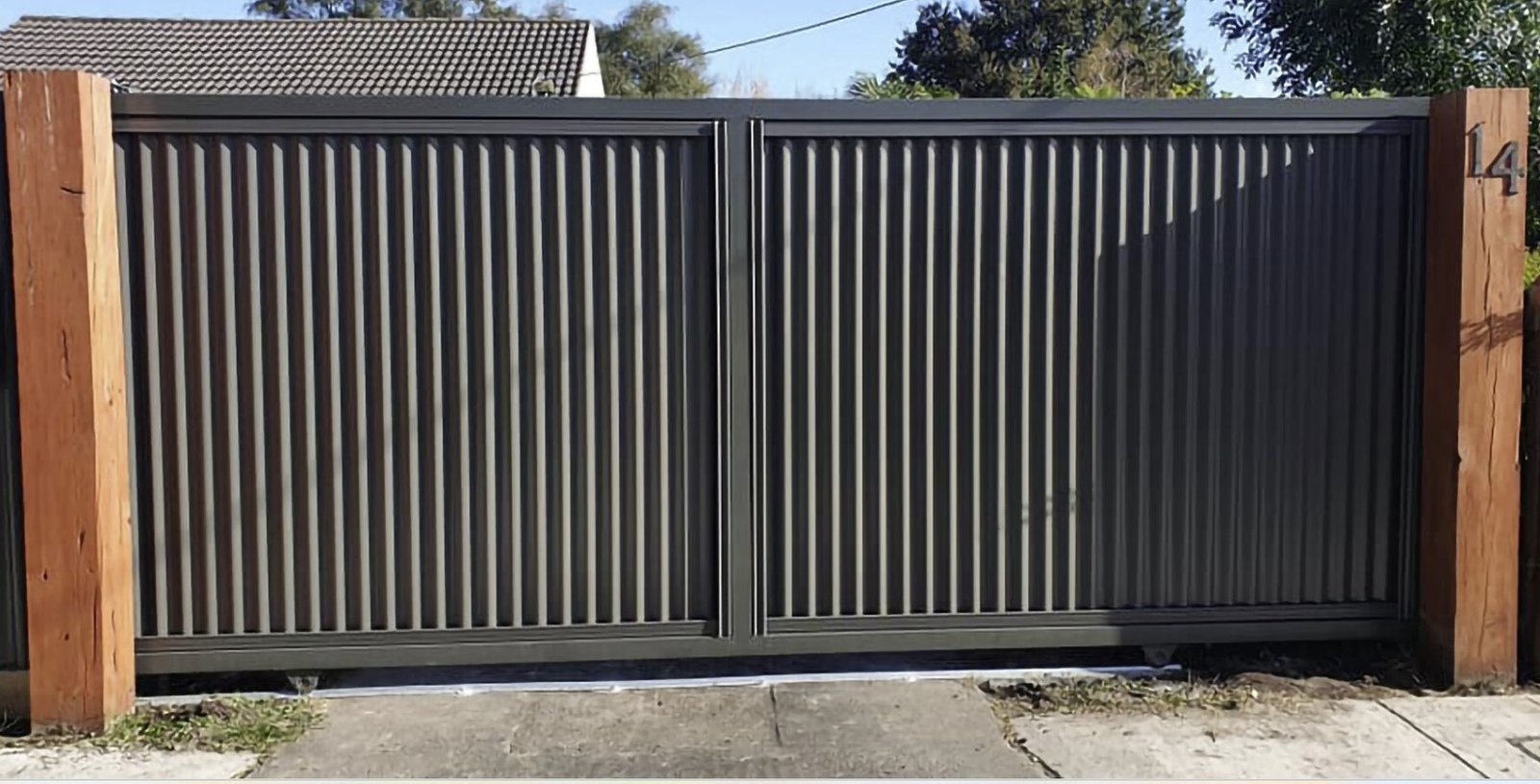 Professional contractors installing a large driveway gate at a Adelaide residential property.